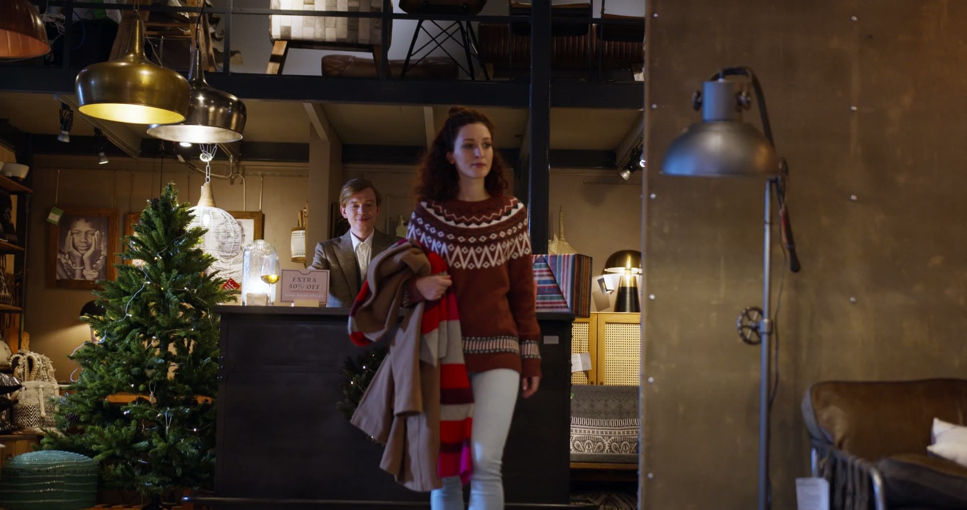 Warm lamplight over vintage furniture and brass fixtures inside the shop