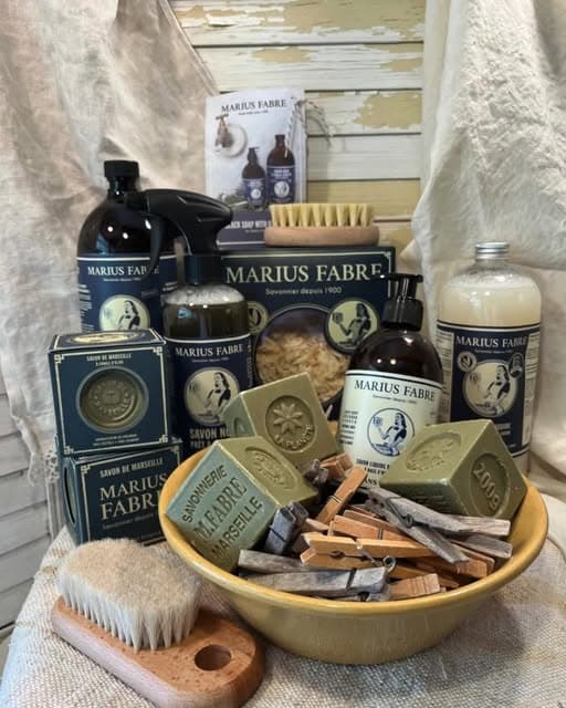 French Marseille soaps, a wooden brush and linen arranged in a still life
